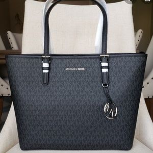 black MK and Tan and white purse and wallet